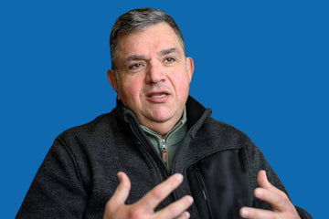 Man speaking with a blue background